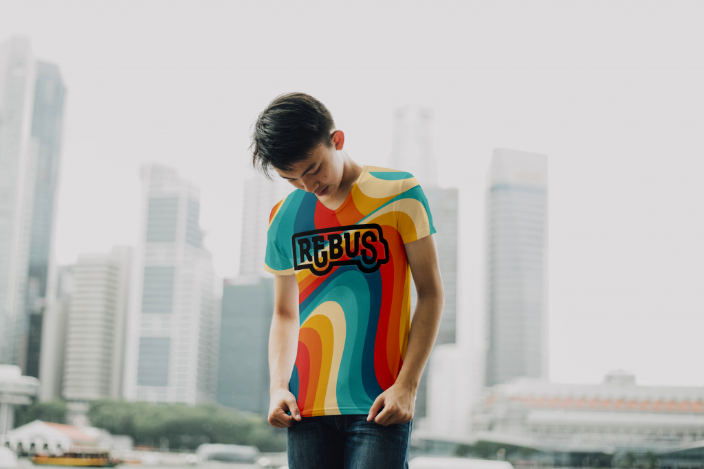 A male model shows off the REBUS rainbow t-shirt.