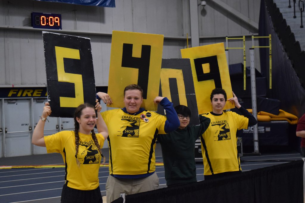 Team members cheer for the robot at Windsor 2019