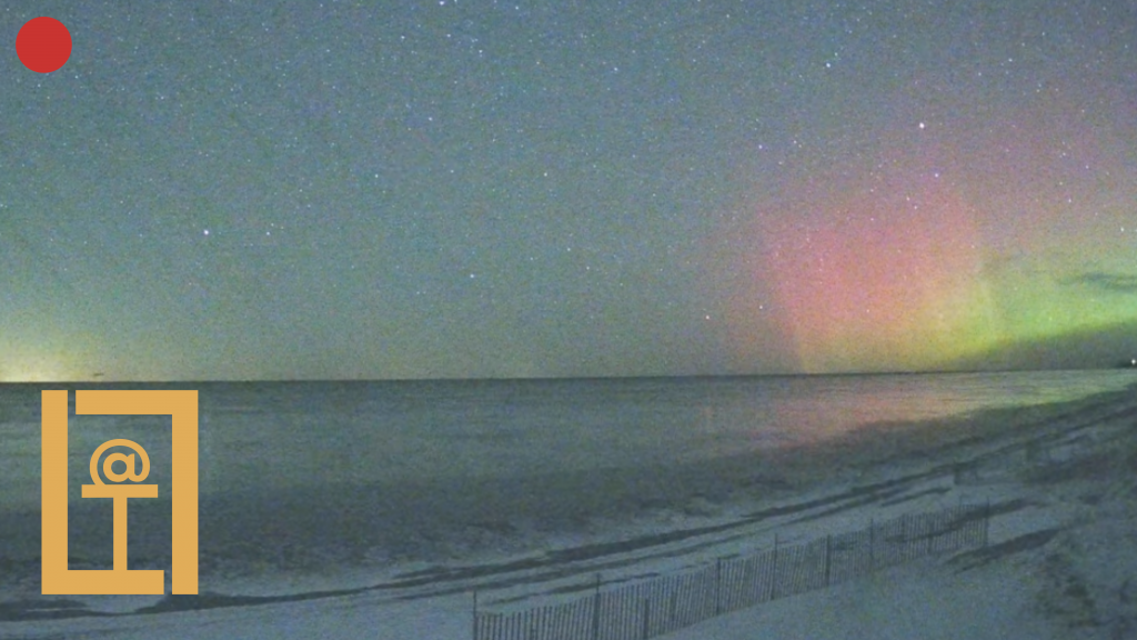 A photo of the beach with northern lights visible on the right side and the Live @ The Lake logo on the left.